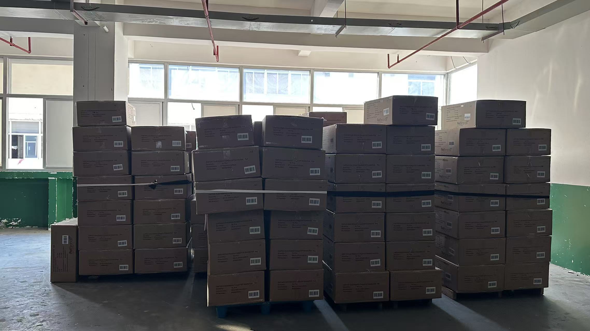 Export-ready horse tack master boxes labeled with barcodes and shipping marks, secured on pallets for ocean freight container loading.