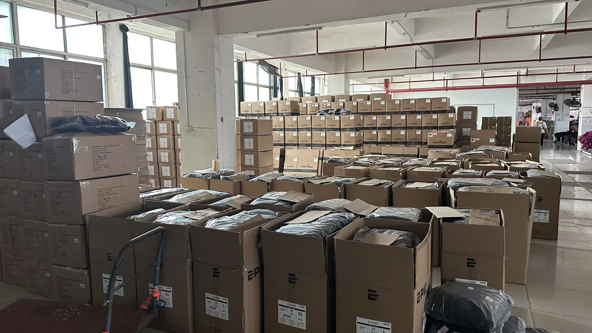 Bulk production of private label horse saddle pads packed in master cartons inside the Carlson Saddlery factory warehouse.